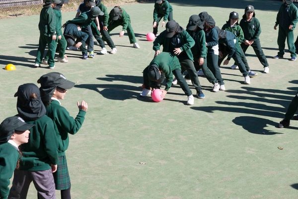 St Francis Xavier Catholic Primary School Ashbury - students in line passing the the ball at school