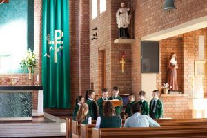 St Francis Xavier Catholic Primary School Ashbury - students reading the bible inside a church