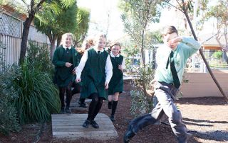 St Francis Xavier Catholic Primary School Ashbury - students running through courtyard