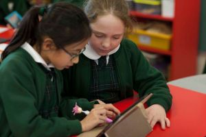 St Francis Xavier Catholic Primary School Ashbury - students looking at IPad